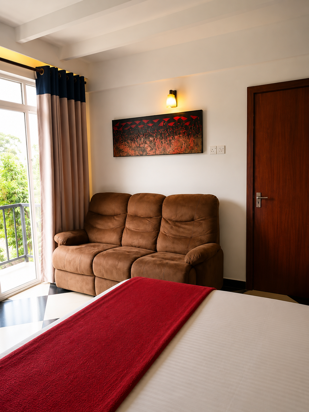 Standard Double Room with bed, sofa, balcony light and warm timber finishes